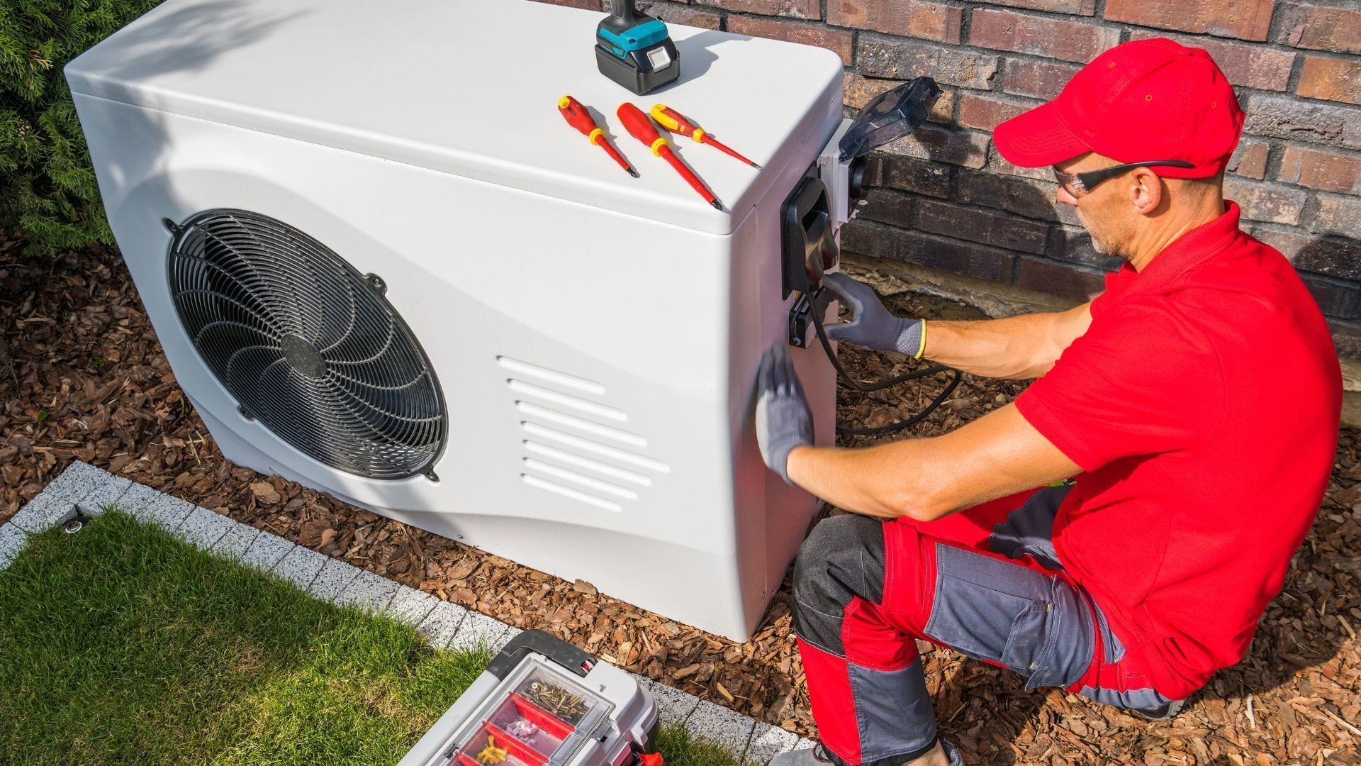 HVAC technician servicing an outdoor heat pump unit